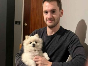 Success Stories 1 A happy new owner with his Toy Pom, Gucci, the focus of this toy pom adoption story.